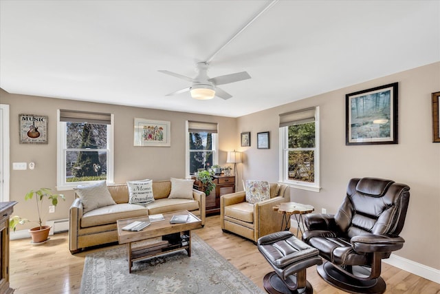 51 Buccaneer Way, Mashpee, MA 02649 - living area with plenty of natural light, light wood-style floors, and a baseboard radiator