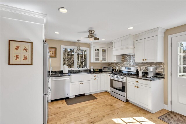 51 Buccaneer Way, Mashpee, MA 02649 - kitchen featuring stainless steel appliances, ceiling fan, dark countertops, white cabinets, and light wood-style flooring