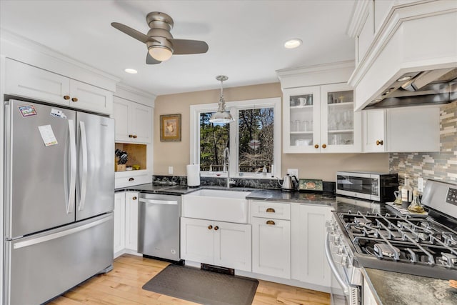 51 Buccaneer Way, Mashpee, MA 02649 - kitchen with appliances with stainless steel finishes, custom range hood, a ceiling fan, white cabinets, and light wood-style floors