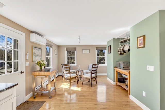 51 Buccaneer Way, Mashpee, MA 02649 - living area with an AC wall unit, light wood-style flooring, and plenty of natural light