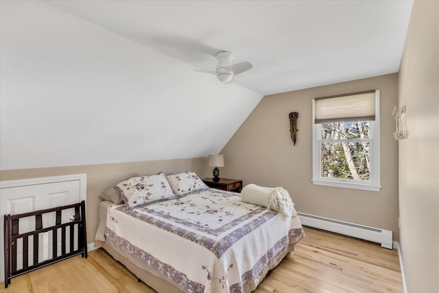51 Buccaneer Way, Mashpee, MA 02649 - bedroom featuring a baseboard heating unit, light wood-style floors, vaulted ceiling, and ceiling fan
