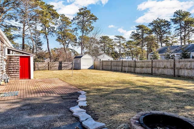 view of yard with a storage shed, a patio area, and an outdoor fire pit