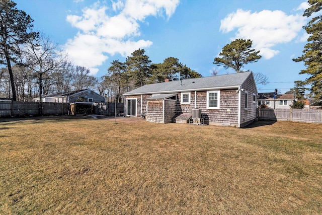 back of house with a lawn