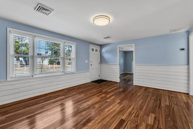 empty room with dark hardwood / wood-style flooring