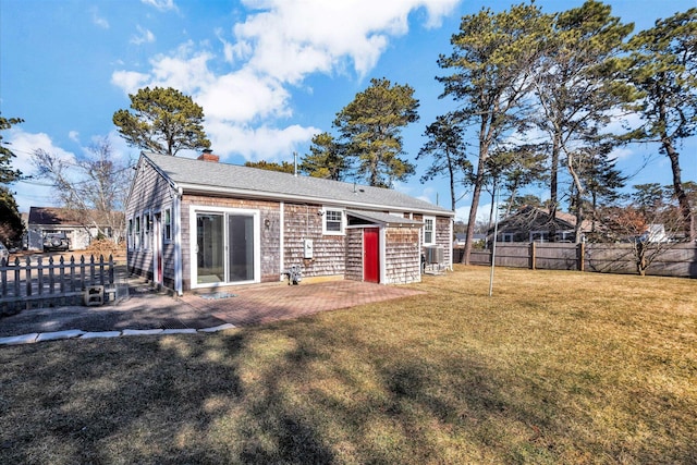 rear view of house with a lawn and a patio area