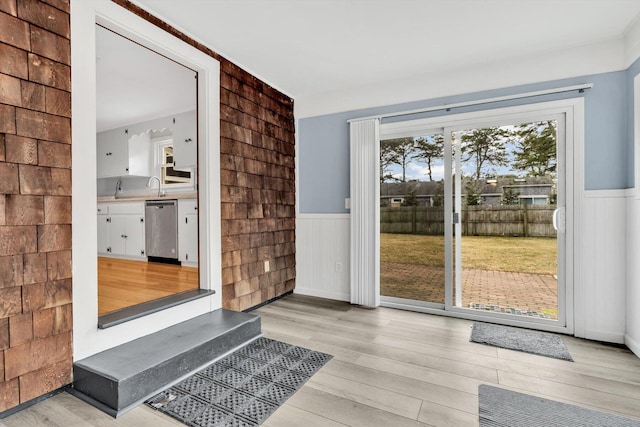 entryway featuring sink and light wood-type flooring