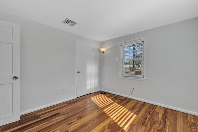 unfurnished room featuring dark hardwood / wood-style floors