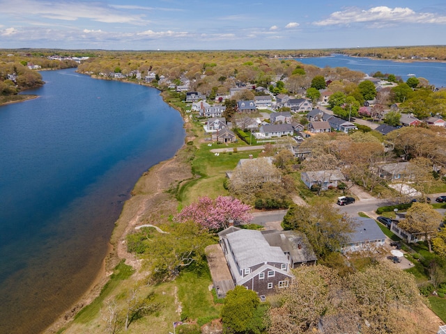 aerial view of property's location featuring a large body of water and nearby suburban area