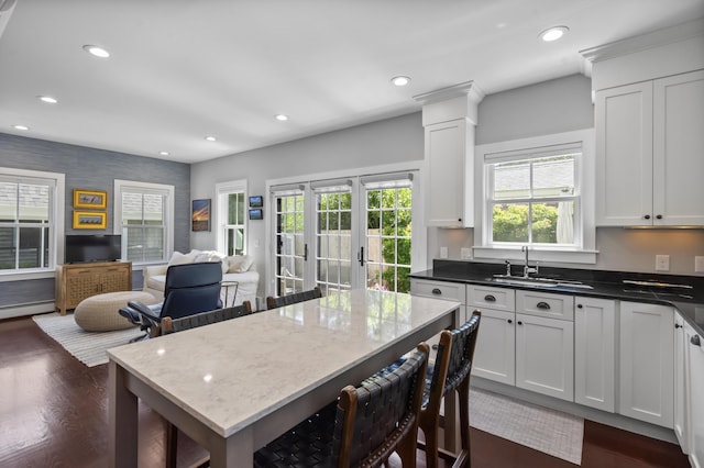 4 Race Rd Unit U2, Provincetown, MA 02657 - kitchen with dark wood-type flooring, a kitchen breakfast bar, recessed lighting, white cabinets, and dark stone countertops