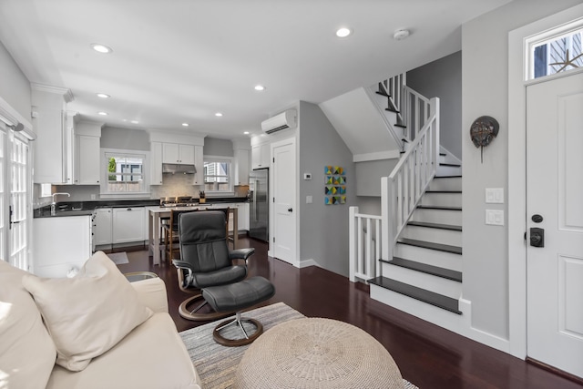 4 Race Rd Unit U2, Provincetown, MA 02657 - living room featuring a wall mounted air conditioner, dark wood-type flooring, stairs, and recessed lighting