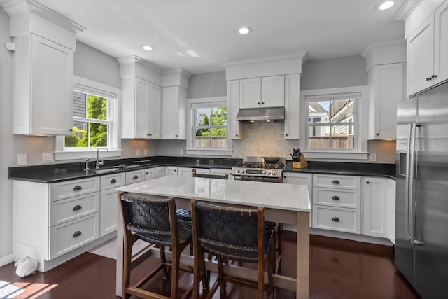 4 Race Rd Unit U2, Provincetown, MA 02657 - kitchen with stainless steel appliances, under cabinet range hood, healthy amount of natural light, recessed lighting, and white cabinets