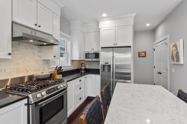 4 Race Rd Unit U2, Provincetown, MA 02657 - kitchen featuring appliances with stainless steel finishes, under cabinet range hood, white cabinets, tasteful backsplash, and recessed lighting