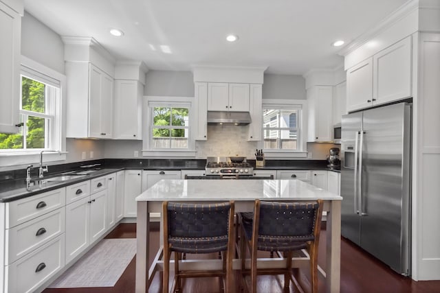 4 Race Rd Unit U2, Provincetown, MA 02657 - kitchen with high quality fridge, under cabinet range hood, range, white cabinets, and recessed lighting