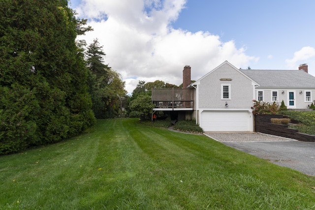 view of yard featuring a wooden deck and a garage