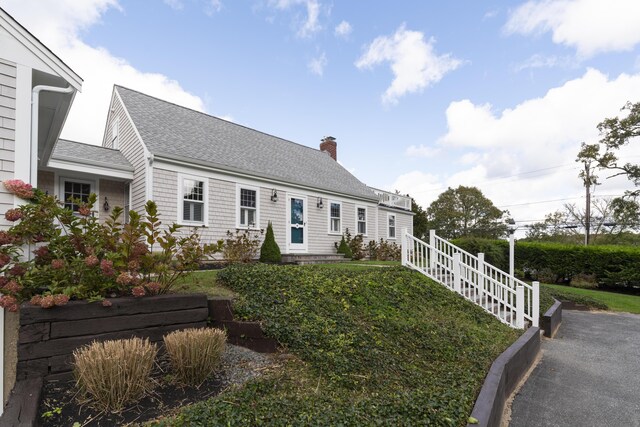 new england style home with a front lawn