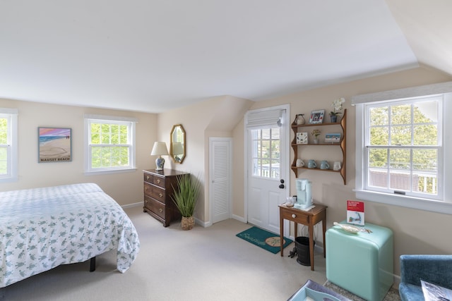 bedroom with light carpet and vaulted ceiling