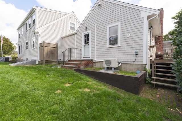 back of house featuring ac unit and a yard