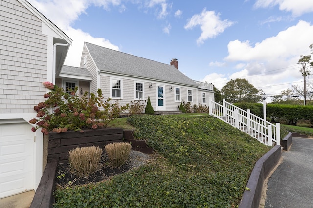 cape cod-style house with a garage