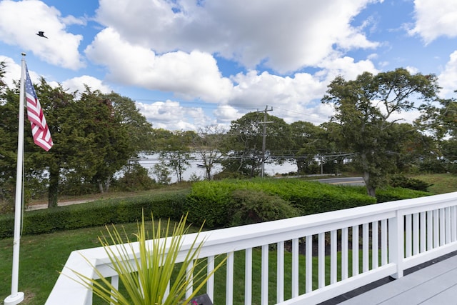 wooden terrace with a lawn