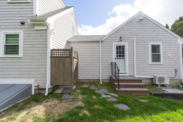 rear view of house featuring ac unit