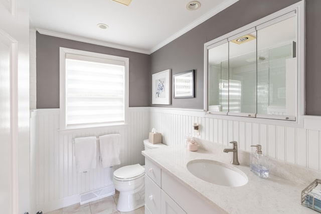 bathroom featuring toilet, vanity, crown molding, and tile patterned flooring