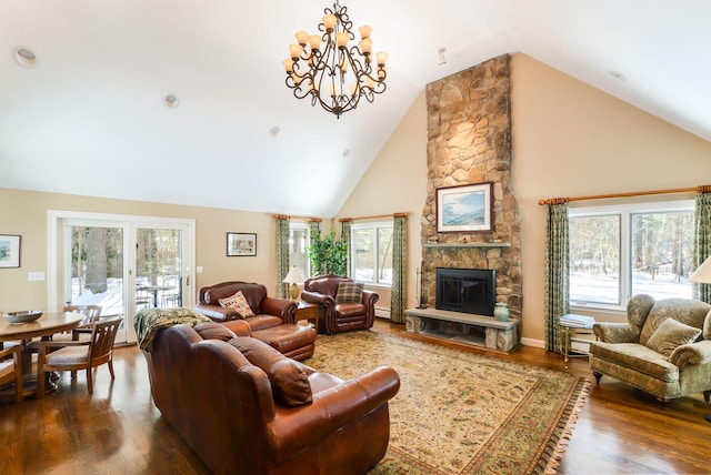 living room with high vaulted ceiling, dark wood-style flooring, and a stone fireplace