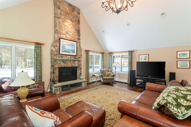 living area with high vaulted ceiling, a fireplace, wood finished floors, baseboards, and an inviting chandelier