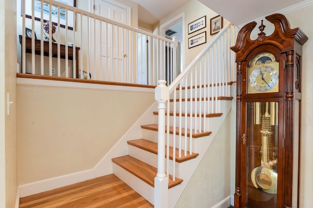 stairs featuring baseboards and wood finished floors