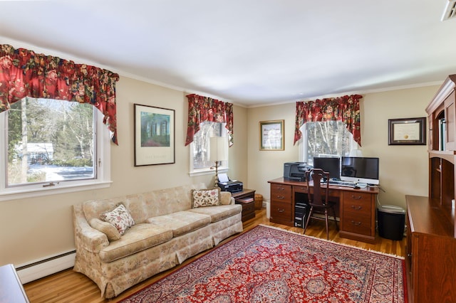 home office featuring baseboard heating, wood finished floors, visible vents, and crown molding