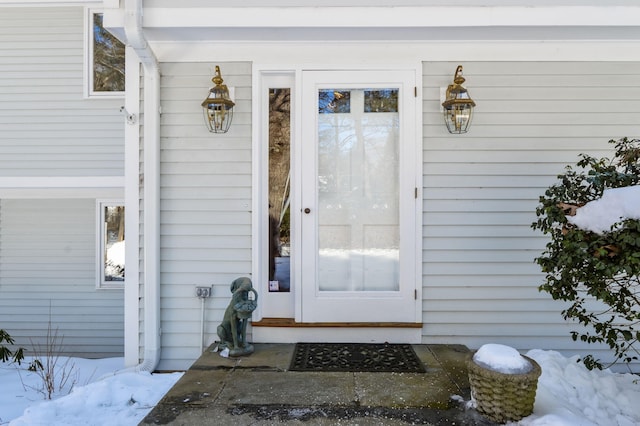 view of snow covered property entrance