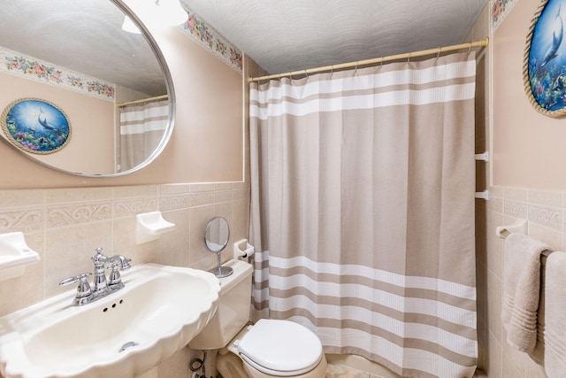 19 Anthony Rd, West Yarmouth, MA 02673 - bathroom with a sink, tile walls, toilet, wainscoting, and a shower with curtain