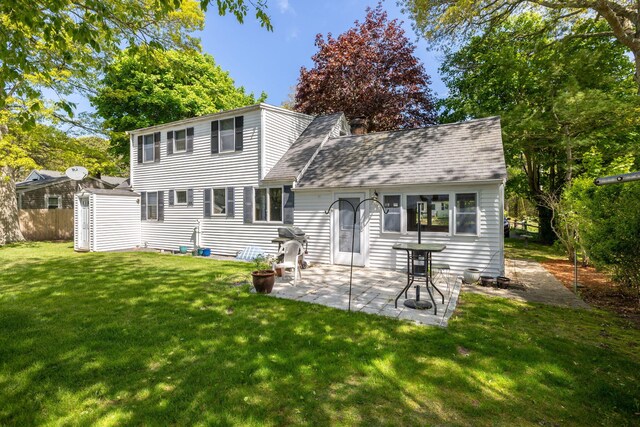 19 Anthony Rd, West Yarmouth, MA 02673 - back of house featuring a lawn, a patio area, and a shingled roof