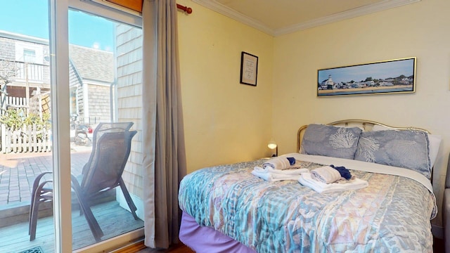 bedroom with access to exterior and crown molding