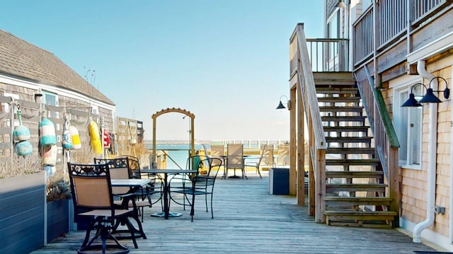 wooden terrace with stairs and outdoor dining space