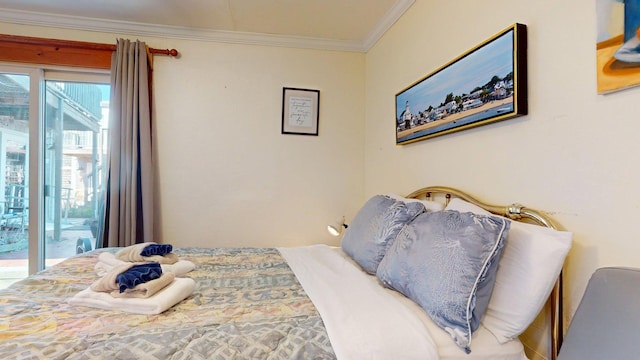 bedroom with access to outside and crown molding