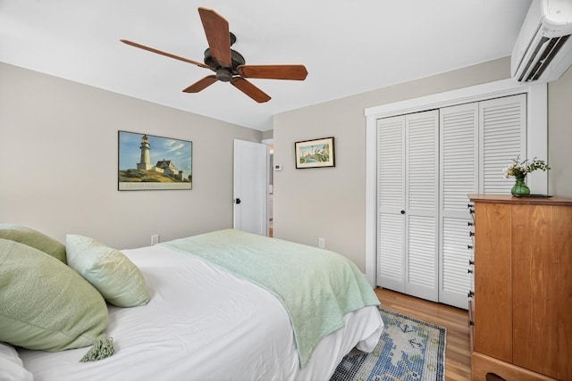 44 Squirrel, Eastham, MA 02642 - bedroom featuring a wall unit AC, wood finished floors, a closet, and ceiling fan