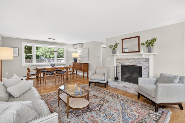 44 Squirrel, Eastham, MA 02642 - living area featuring wood finished floors, a fireplace, and a wall mounted AC