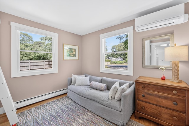 44 Squirrel, Eastham, MA 02642 - sitting room with a baseboard heating unit, a wall mounted AC, plenty of natural light, and wood finished floors
