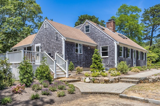 44 Squirrel, Eastham, MA 02642 - view of front of home featuring roof with shingles, a chimney, and a deck