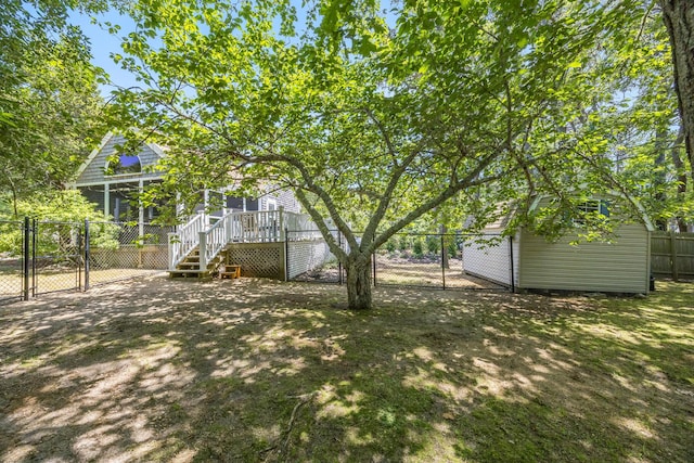 44 Squirrel, Eastham, MA 02642 - fenced backyard with a gate, stairs, a wooden deck, a sunroom, and a shed