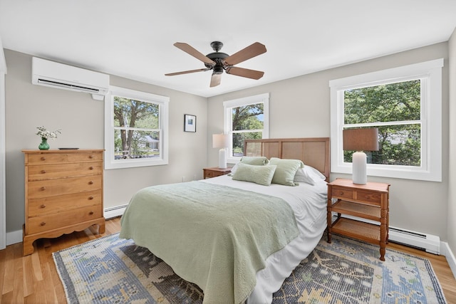 44 Squirrel, Eastham, MA 02642 - bedroom featuring multiple windows, a wall unit AC, and wood finished floors