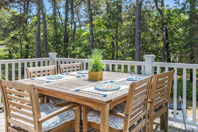 44 Squirrel, Eastham, MA 02642 - wooden terrace featuring outdoor dining space and view of wooded area