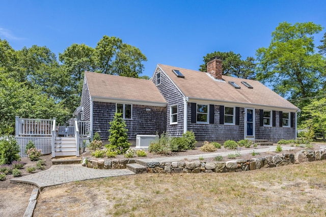 44 Squirrel, Eastham, MA 02642 - view of front of property featuring a wooden deck, a shingled roof, and a chimney