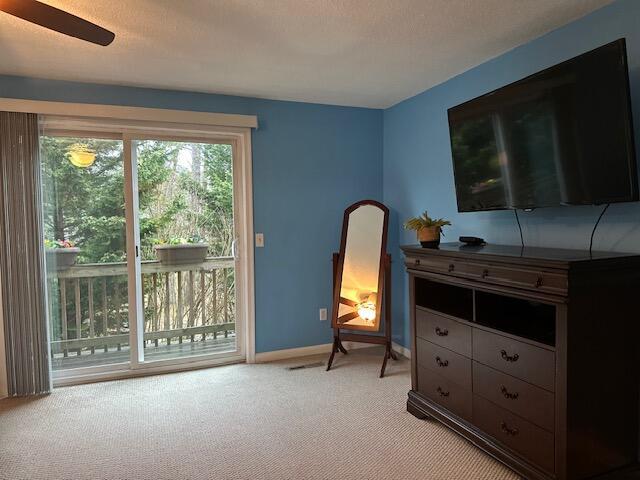sitting room with light colored carpet and baseboards