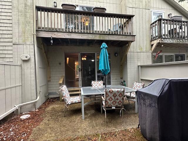 view of patio / terrace with grilling area, outdoor dining space, and a balcony