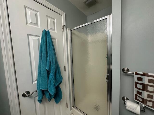 full bathroom with visible vents and a shower stall