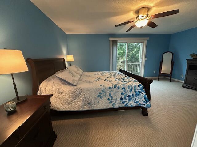 bedroom featuring access to exterior, a ceiling fan, carpet floors, and baseboards