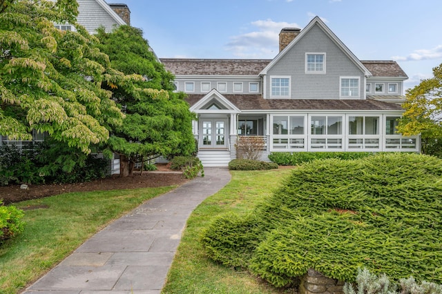 view of front of home with a front yard and french doors