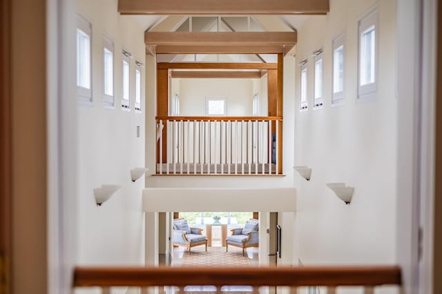 stairway featuring a towering ceiling