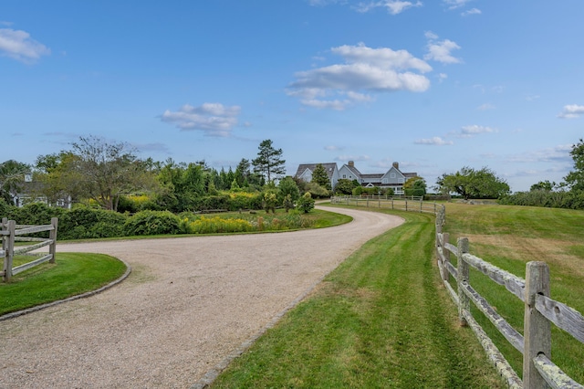 view of home's community with a lawn and a rural view